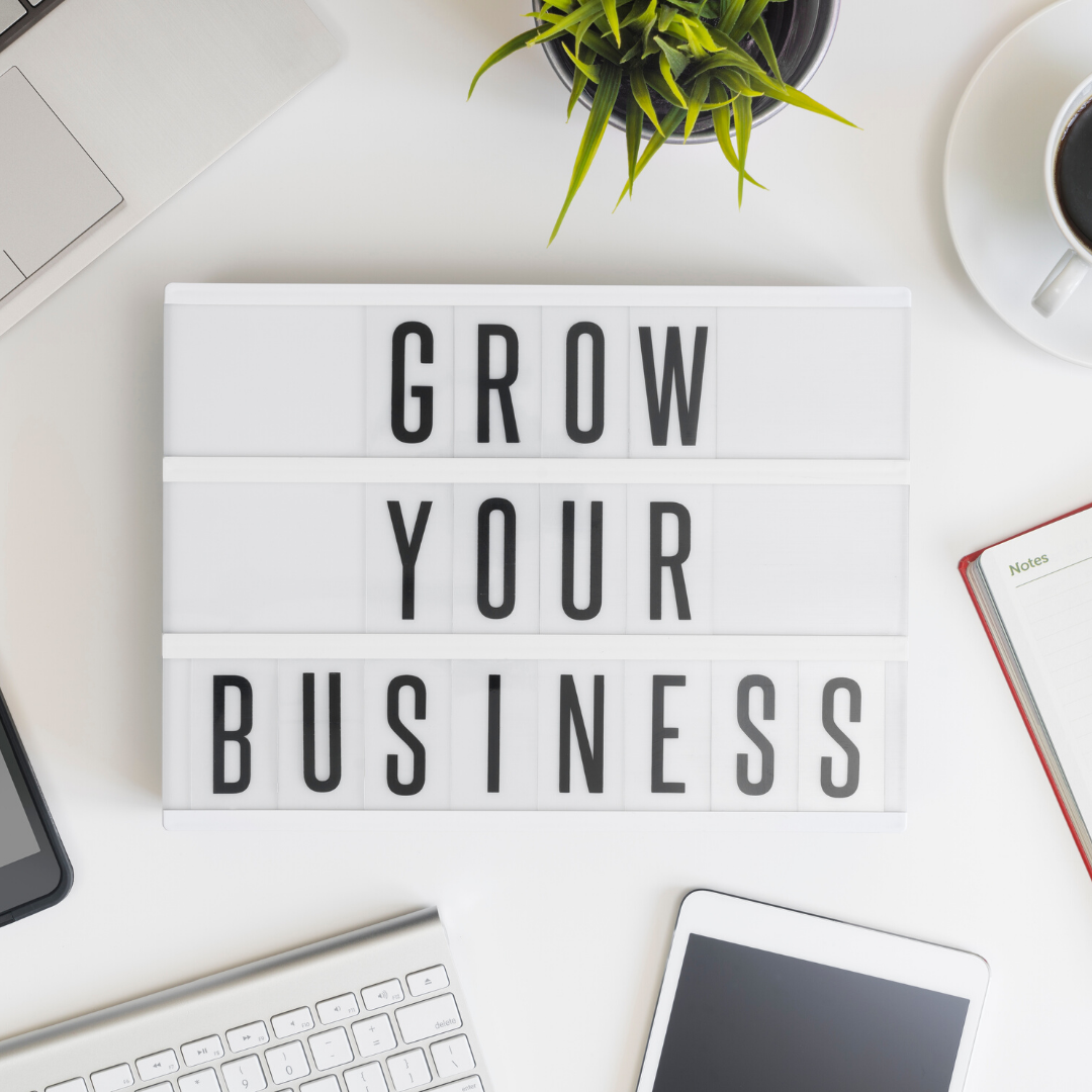 Sign on a desk with Grow Your Business written